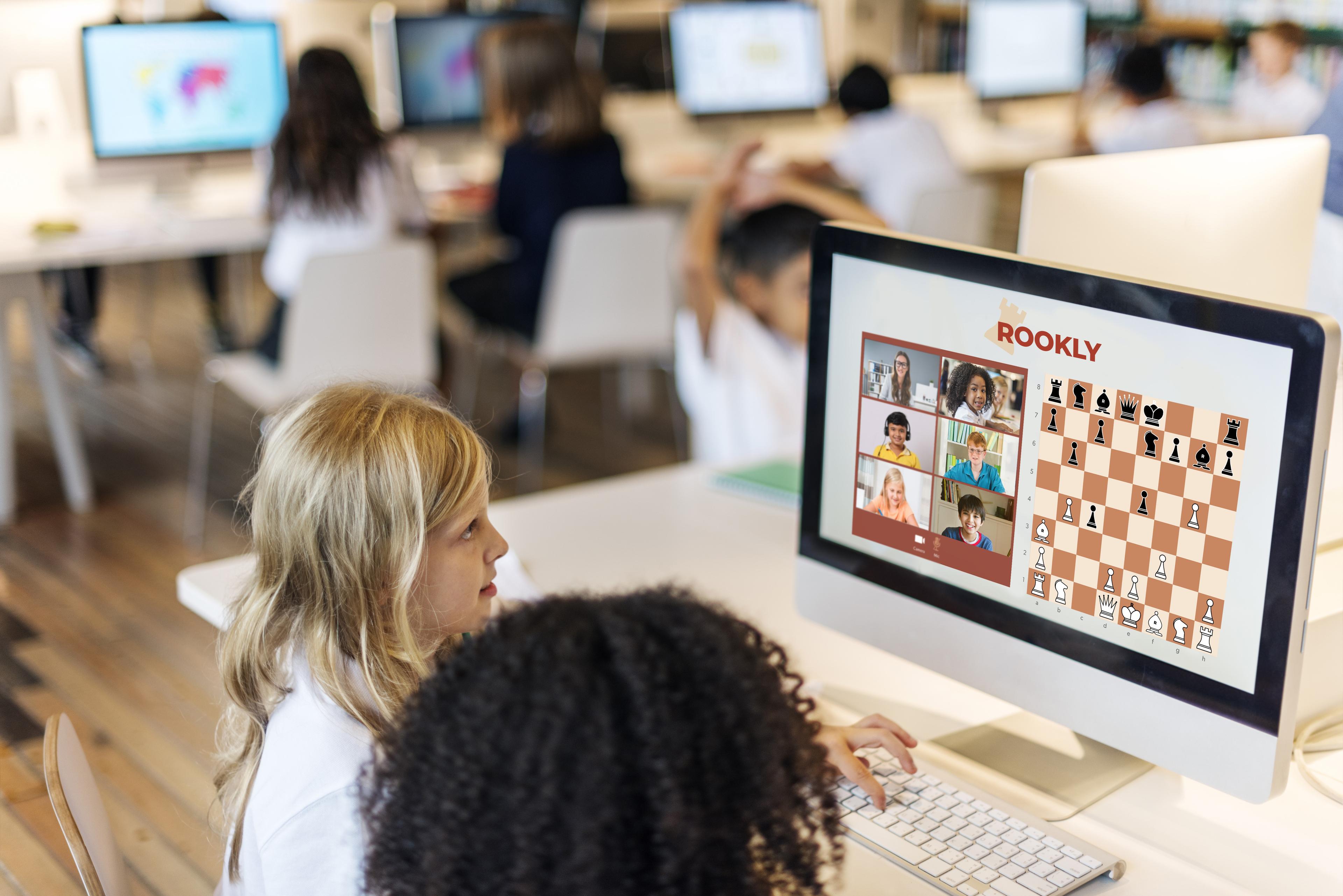 Girl playing chess on a screen in a classroom