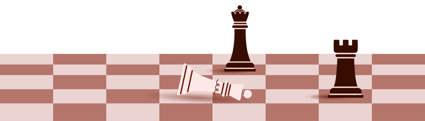 A queen knocked over alongside another queen and rook on a chessboard